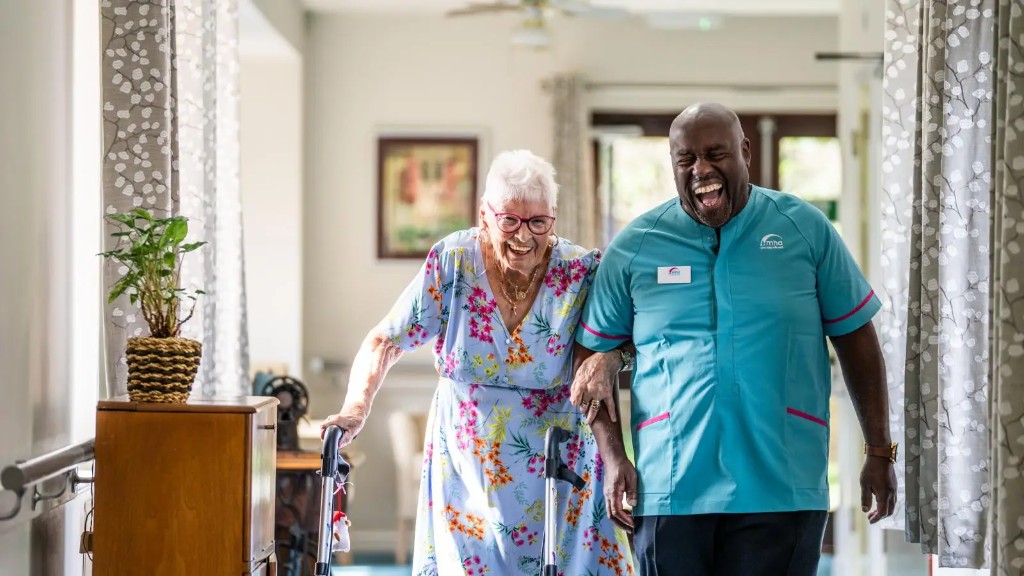 MHA carer and resident laughing together