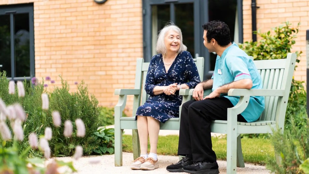 MHA carer and resident talking in the garden